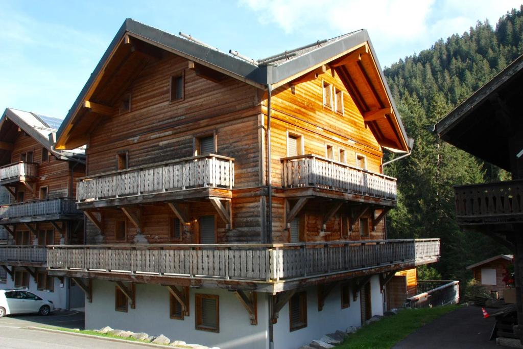 a large wooden house with balconies on the side of it at Chesery 8 in Morgins