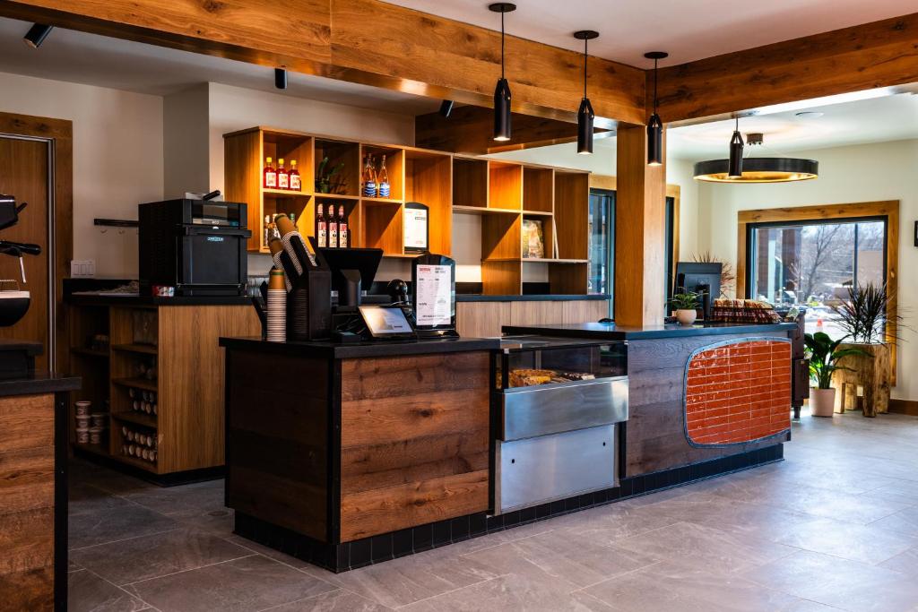 a large kitchen with wooden cabinets and a counter at Boundary Hotel By Terra Vi, Durango in Durango