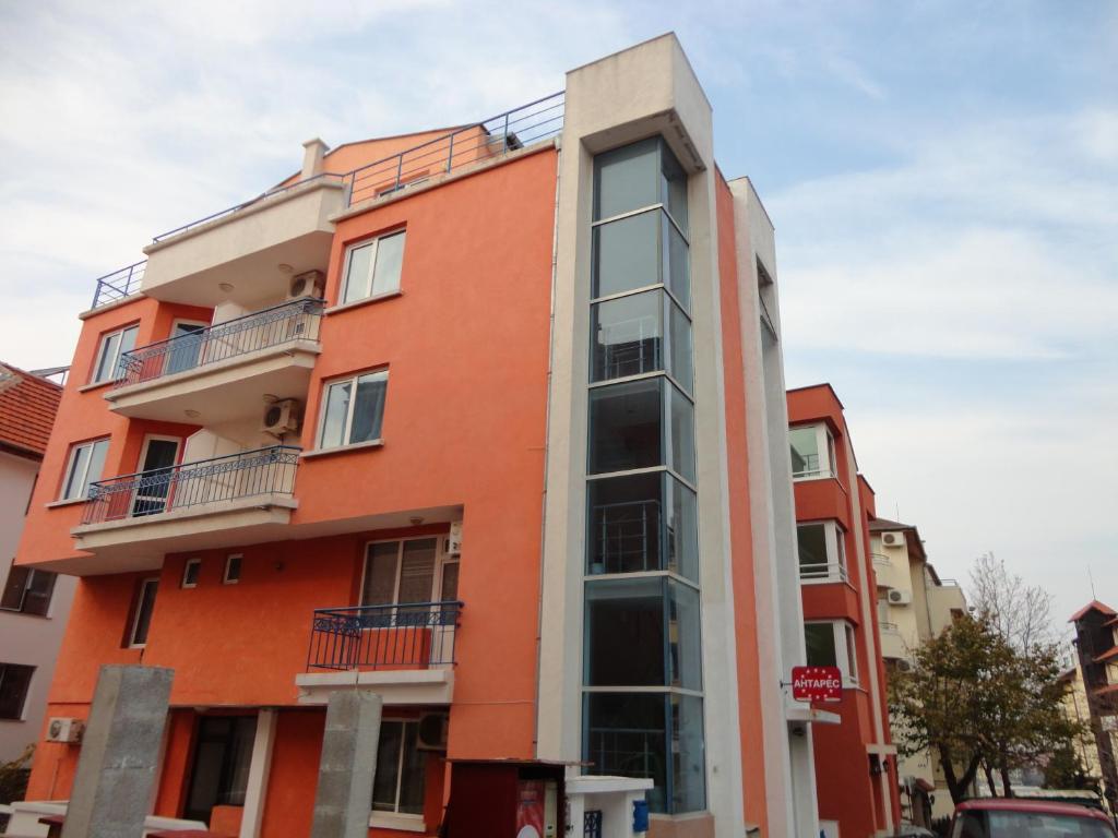 an orange building with balconies on top of it at Sargas Sozopol in Sozopol