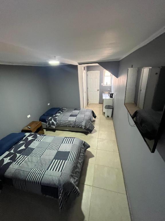 two beds in a room with blue walls at Hostal JV Loft Doble A in Nogales
