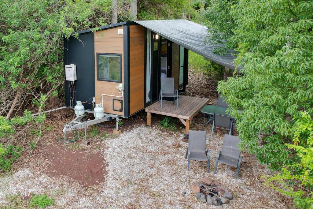 an overhead view of a tiny house in the woods at Hill Creek Tiny House 5 by Tiny Away in Perwillowen