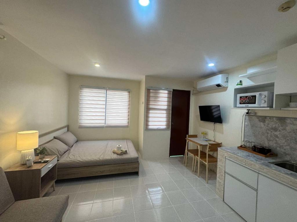 a living room with a couch and a tv at Las Fallas Staycation in Santa Rosa