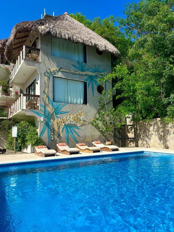 a resort with a swimming pool and a building at Sicaru Mazunte in Mazunte
