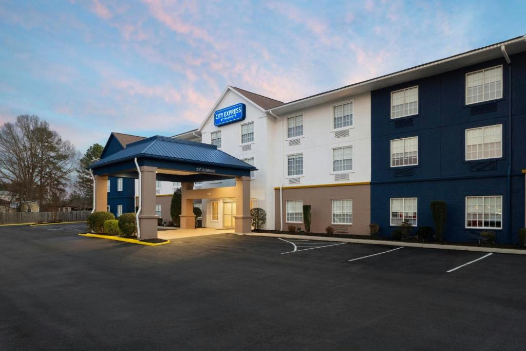 a hotel with a parking lot in front of it at City Express by Marriott Danville in Danville