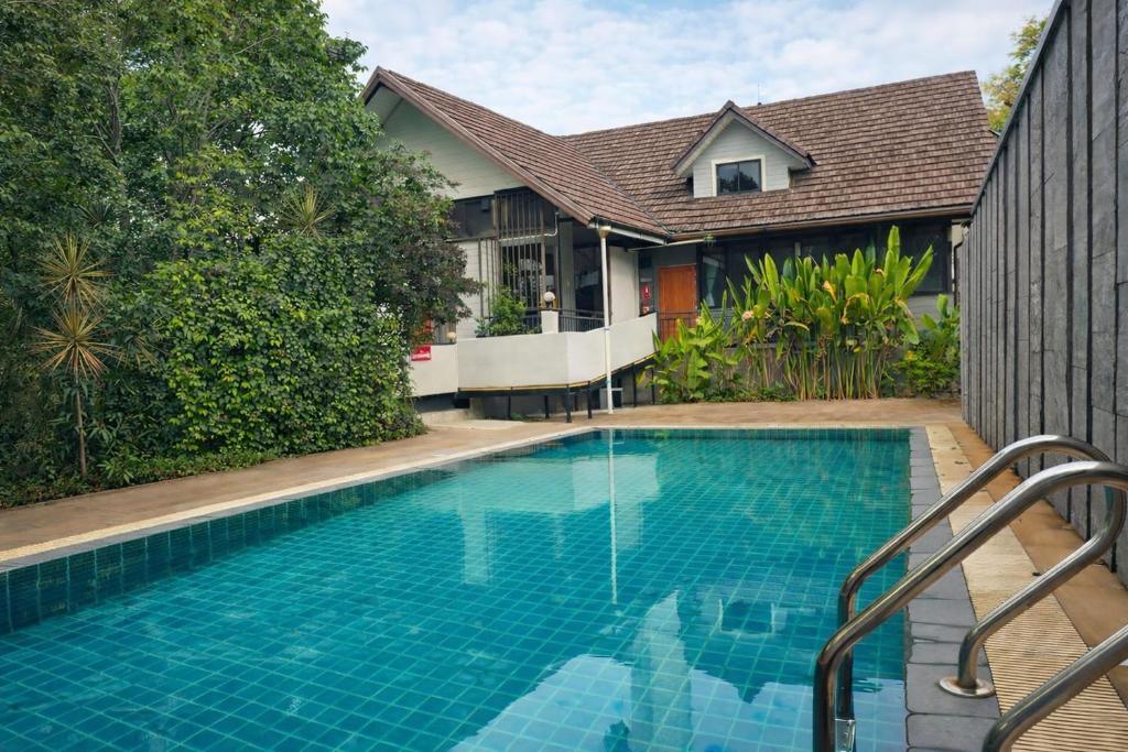 a swimming pool in front of a house at Rayong Valley Resort in Ban Khao Chak Khaek (1)