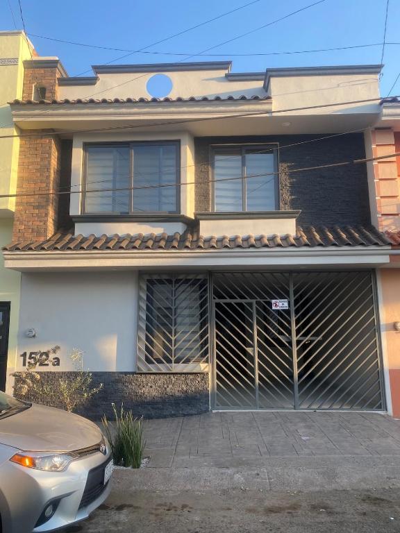a house with a car parked in front of it at Casa Mexiquito in Arandas