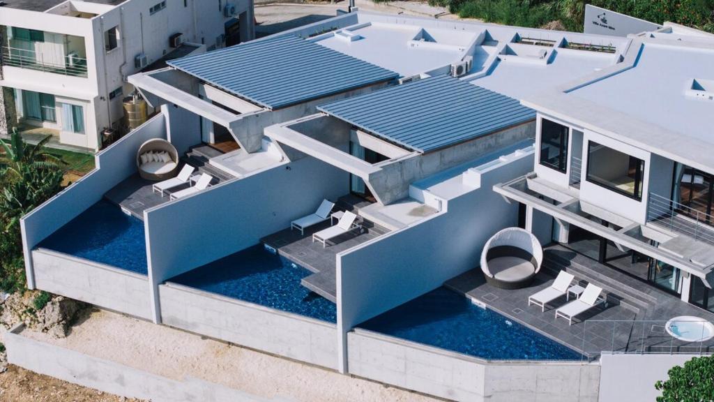 an aerial view of a house with a swimming pool at Villa Azure Mira in Miyakojima