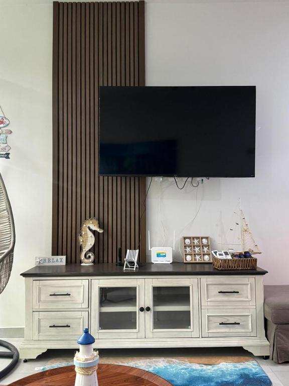 a large entertainment center with a television on top of it at Departamento San Lorenzo #102 in Mazatlán
