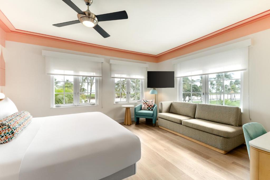 a bedroom with a bed and a couch at Waldorf Towers South Beach in Miami Beach