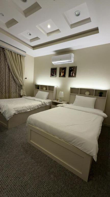 a bedroom with two beds and aception at مسكن الفخامة in Taif