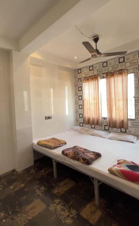 a bed in a room with two pillows on it at HOTEL IN UJJAIn in Ujjain