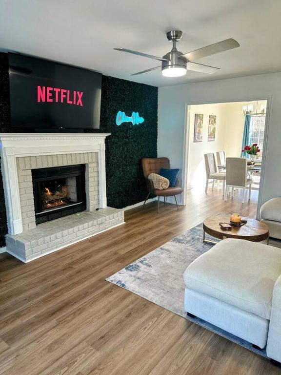 a living room with a couch and a fireplace at Summerville’s Charm House in Summerville