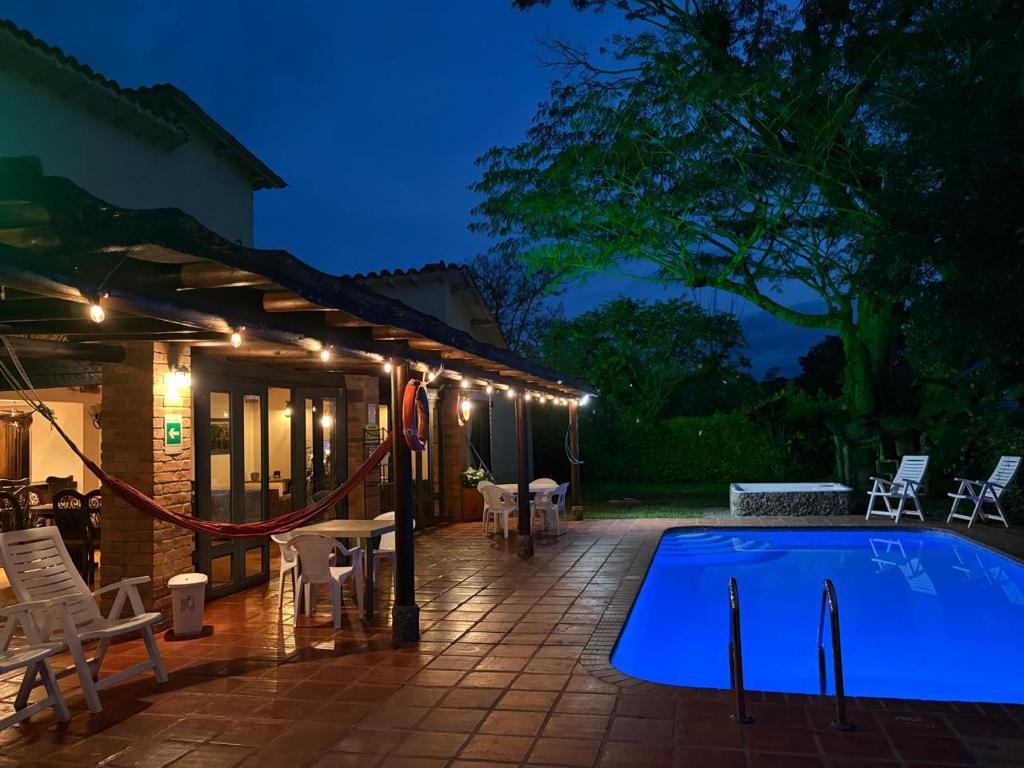 a patio with a swimming pool at night at Casa Panaca Portal 12 in Quimbaya