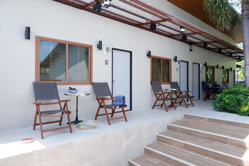 a patio with a bunch of chairs and a table at Villa nabon in Ban Suan