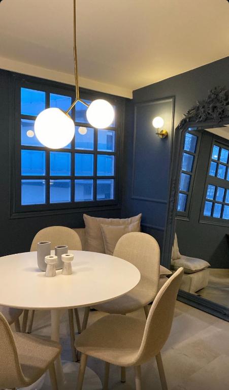 a dining room with a white table and chairs at Loft 038 City Center in Heraklio