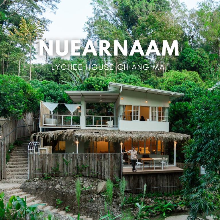 a house with a sign that reads nederlandiane hospice house changing man at Nuearnaam Lychee House Chiang Mai in Ban Pa Miang