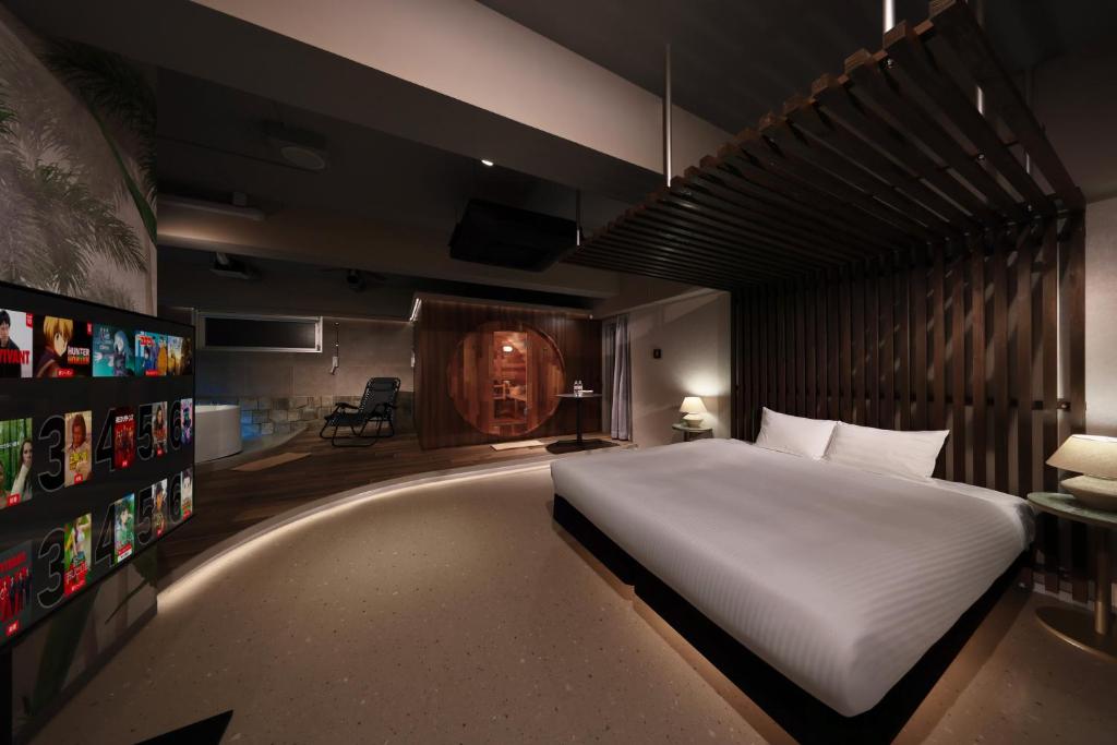 a bedroom with a large white bed in a room at クリスタルサウナ in Miyako-jima