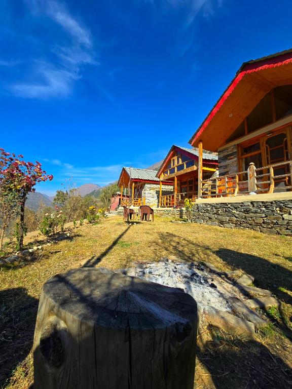 a house with horses in the yard in front of it at River View Sunrise Cottages Tirthan Valley in Kulu
