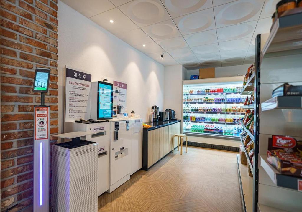 a grocery store with a counter and a brick wall at Incheon Juan Chungchoon Hotel in Incheon