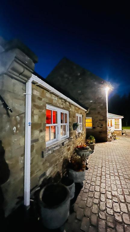 a stone building with a window and a street light at Waterside annexx in Durham
