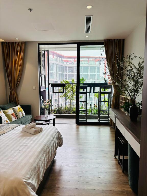 a hotel room with a bed and a large window at Măng Homestay in Xuân Quan
