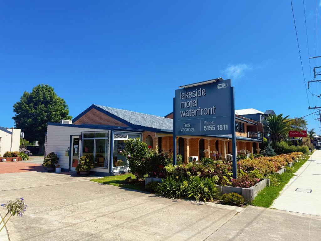 a sign in front of a water front at Lakeside Motel Waterfront in Lakes Entrance