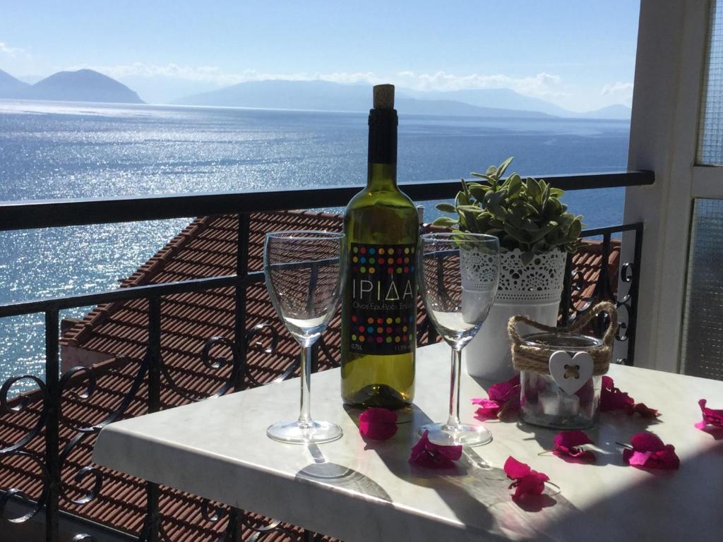a bottle of wine sitting on a table with two glasses at Sea Sound in Vasiliki