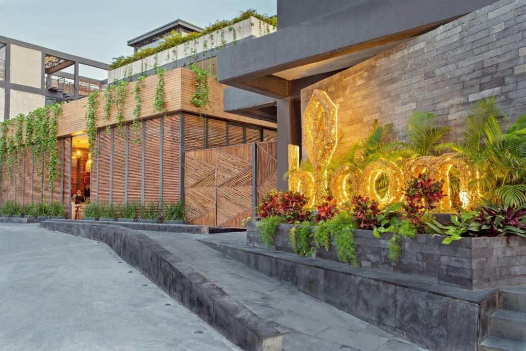 a building with a sign that reads hotel at Bloom Tulum, Apartments by Marriott Bonvoy in Tulum