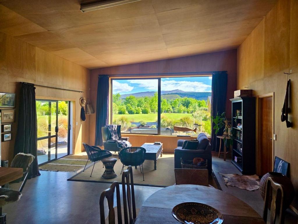 a living room with a large window with a view at Barn Apartment in Earnscleugh