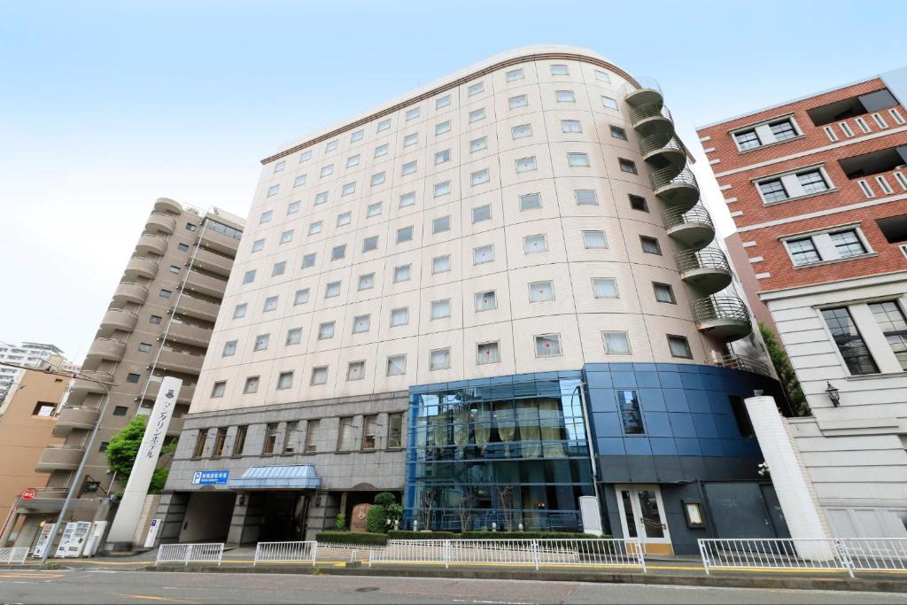a large white building with a glass window at Yokohama Mandarin Hotel in Yokohama