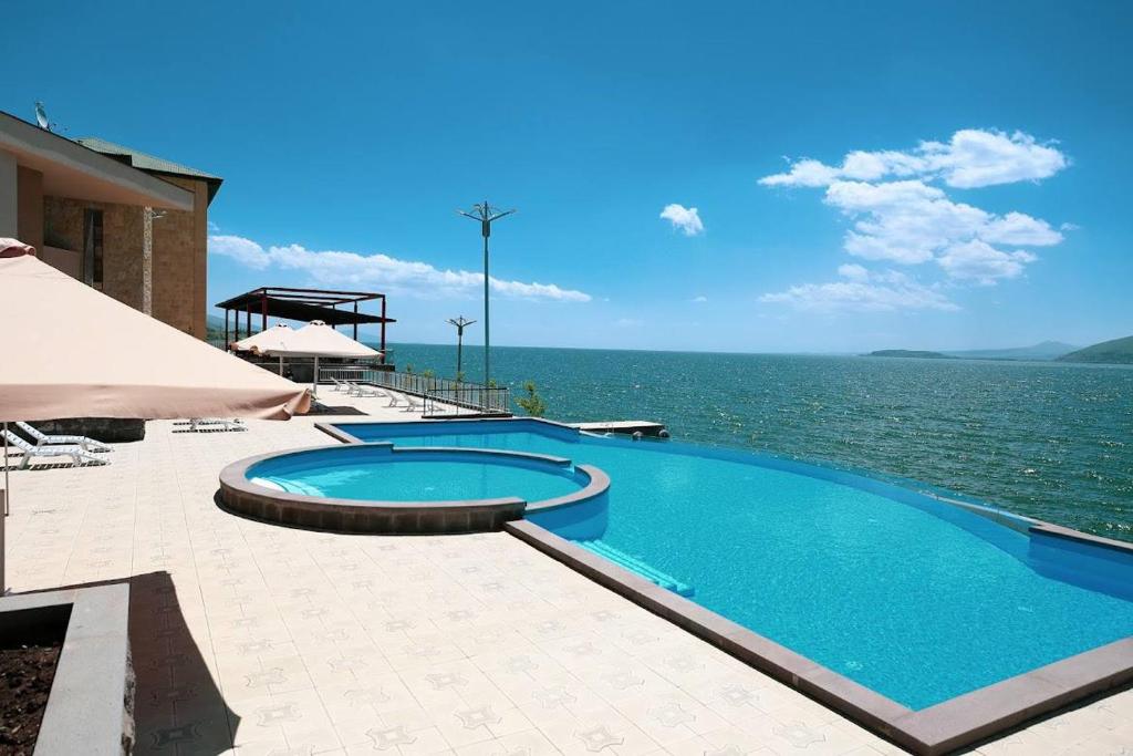 a large swimming pool next to the ocean at Sevan Up In in Aghk'ilisa