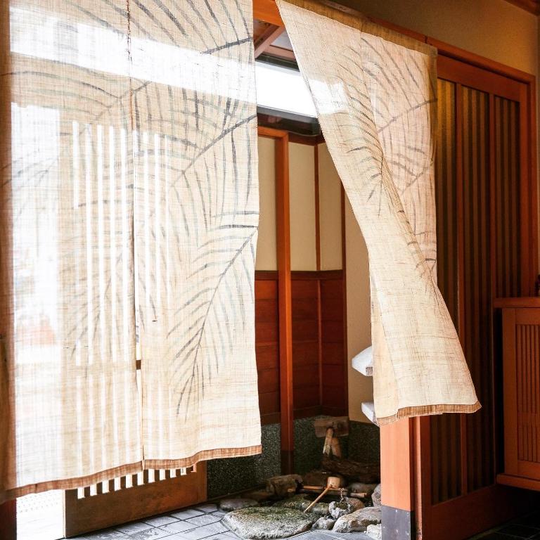 a pair of curtains are hanging in a room at 春日旅館-Kasuga Ryokan- in Nabari