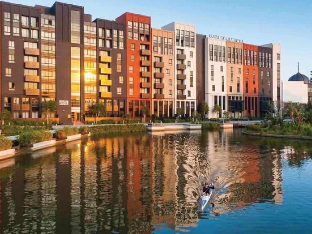a group of buildings next to a river at Century City Hotel Bridgewater in Cape Town