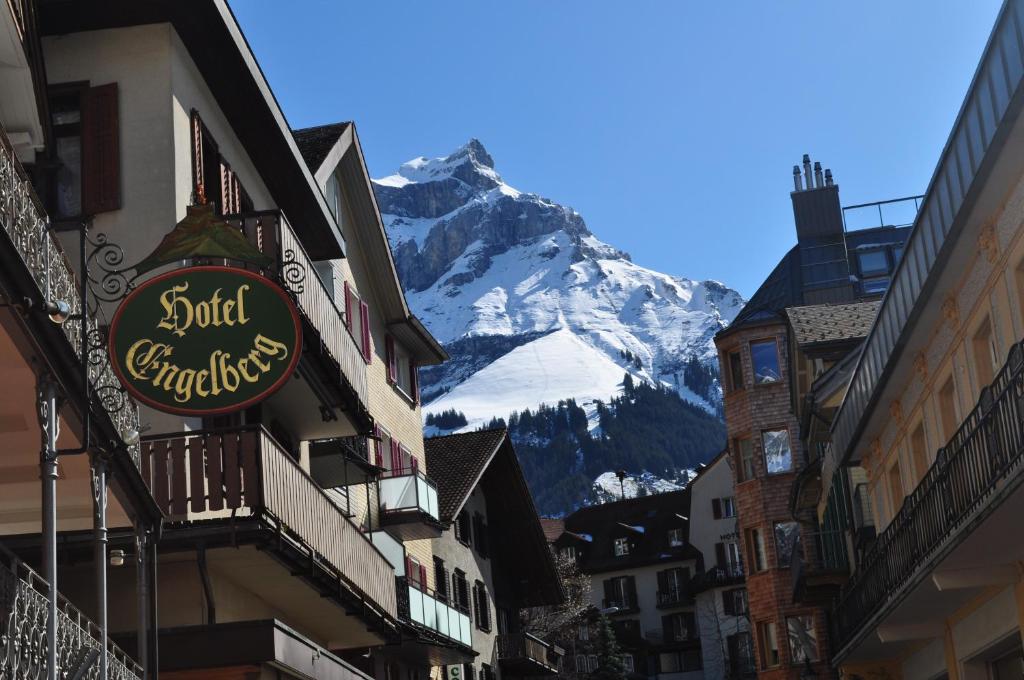 a view of a snow covered mountain from a street at Hotel Engelberg "mein Trail Hotel" in Engelberg