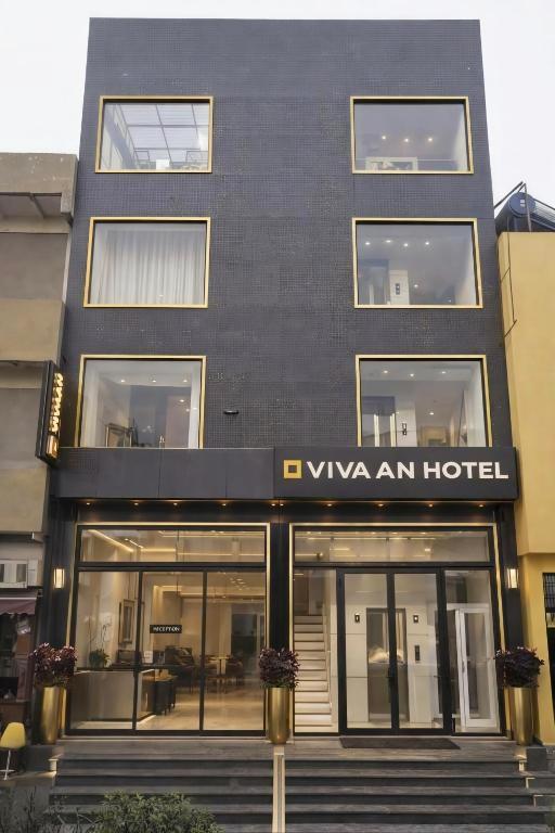 a black building with a sign for a hotel at Hotel Vivaan - Walk to Banke Bihari Temple in Vrindāvan