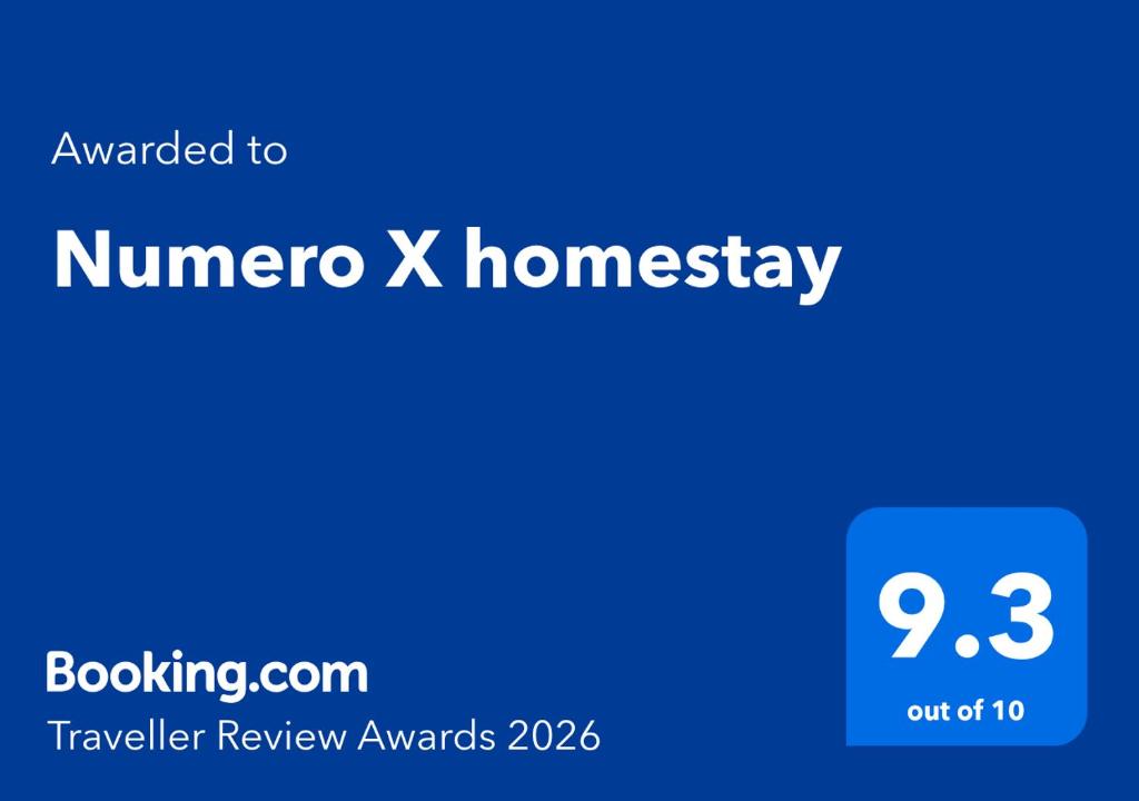 a blue sign with the words number x homogeneity at Numero X homestay in Kajang