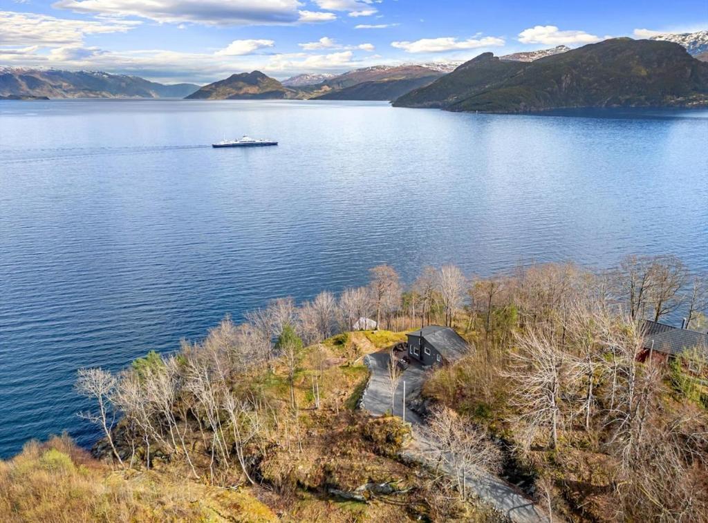 a view of a lake with a boat in the water at Look at this view! 3 BR house overlooking Hardangerfjorden in Kvam