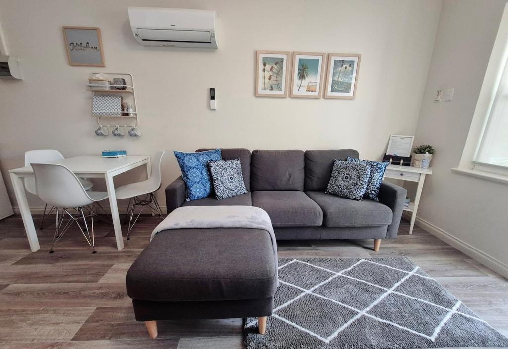 a living room with a couch and a table at Number 4 Smugglers Inn in Victor Harbor