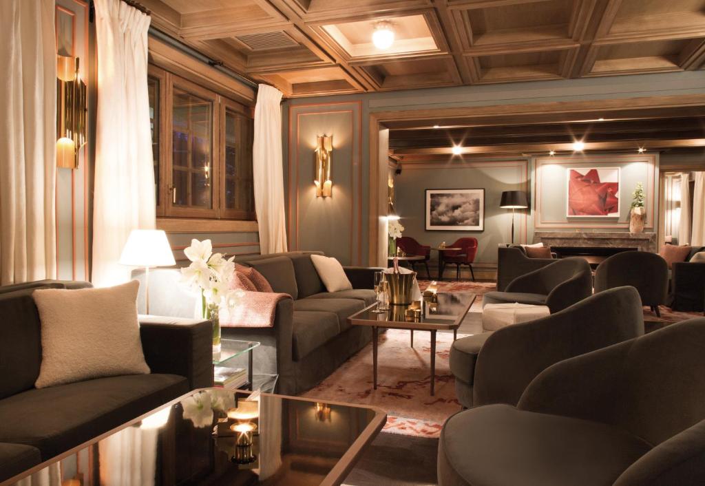a living room with couches and a table at Apogée Courchevel, Oetker Hotels in Courchevel