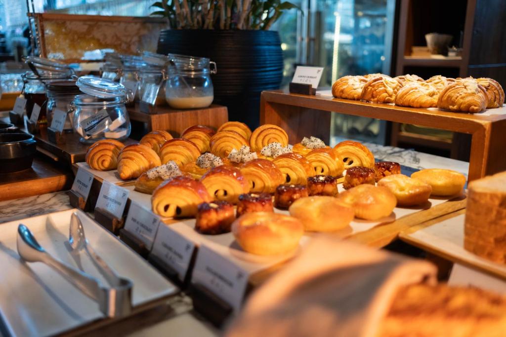 A close-up of assorted breakfast pastries arranged on a buffet counter.