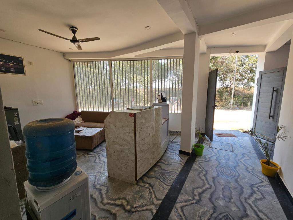 a living room with a couch and a ceiling fan at the varun residency in Greater Noida