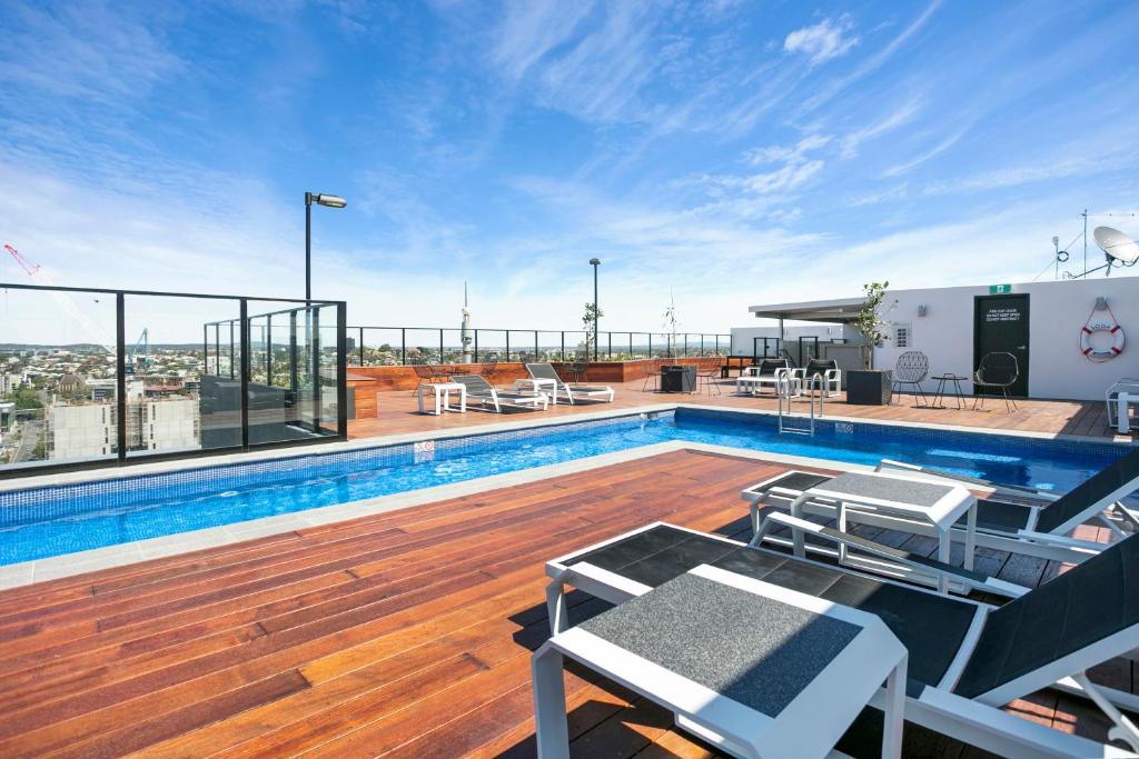 a swimming pool on the roof of a building at Soda Apartments by CLLIX in Brisbane