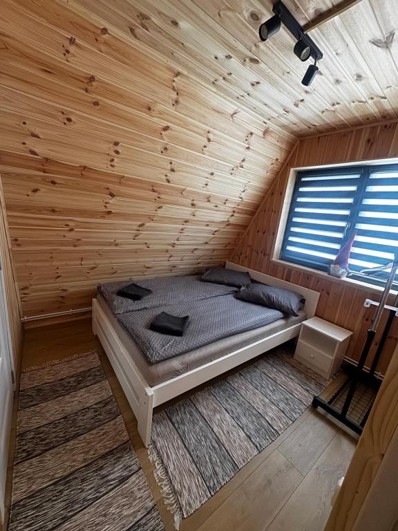 a bedroom with a bed in a wooden cabin at 3A-Chalet-Liban in Liban