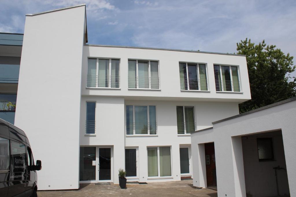 a white building with a lot of windows at Brenzapartments Heidenheim in Heidenheim an der Brenz