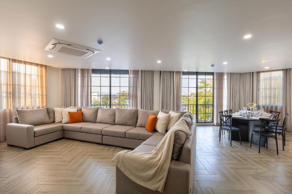 a living room with a couch and a dining room at Holmes Pranakorn in Bangkok