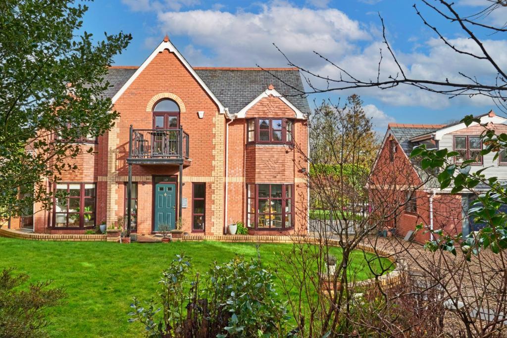 a large brick house with a green door at Finest Retreats - Sea Gables in Exmouth