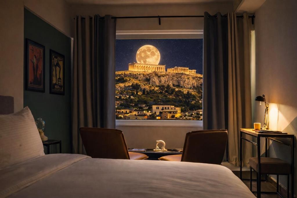 a hotel room with a view of the moon at Elite Ermou Suites in Athens