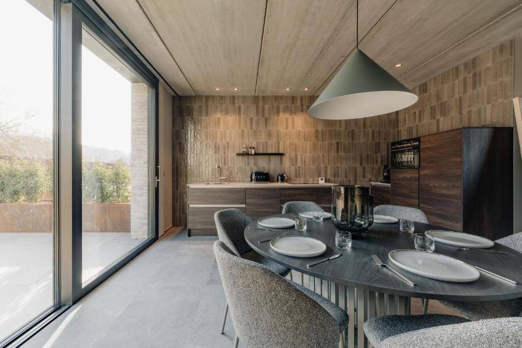 a dining room with a table and chairs at Coliving - Bord de Meuse - L'écrin Vert in Oupeye
