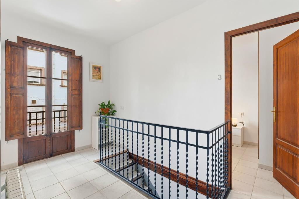 a hallway with a staircase and a wooden door at Rustica, Centrica & Agradable in Palma de Mallorca