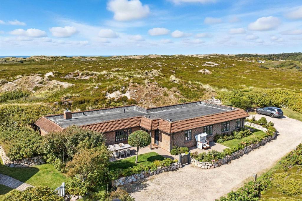 an aerial view of a house with a car parked in the driveway at Beach Bungalow Sylt 1 in Dikjendeel